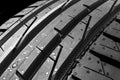 Studio shot of a set of summer car tires on black background. Tire stack background. Car tyre protector close up. Black rubber tir Royalty Free Stock Photo