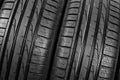 Studio shot of a set of summer car tires on black background. Tire stack background. Car tyre protector close up. Black rubber tir Royalty Free Stock Photo