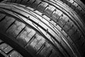 Studio shot of a set of summer car tires isolated on black background. Tire stack background. Car tyre protector close up. Black r Royalty Free Stock Photo