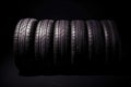 Studio shot of a set of summer, fuel efficient car tires on black background