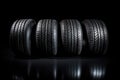 Studio shot of a set of summer, fuel efficient car tires on black background