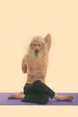 Studio shot of senior bearded man doing yoga poses with hands in the back shirtless Royalty Free Stock Photo