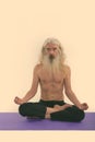 Studio shot of senior bearded man meditating shirtless Royalty Free Stock Photo