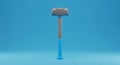 Sledgehammer Tool With Blue Handle and Gray Head on a Blue Background construction demolition Royalty Free Stock Photo