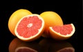 Studio shot sliced three grapefruits isolated black