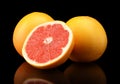 Studio shot sliced three grapefruits isolated black