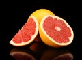Studio shot sliced three grapefruits isolated black