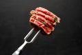 Studio shot of slices of steak on a meat fork Royalty Free Stock Photo