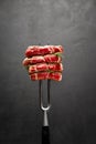 Studio shot of slices of steak on a meat fork Royalty Free Stock Photo