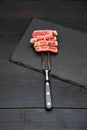 Studio shot of slices of steak on a meat fork Royalty Free Stock Photo