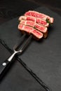 Studio shot of slices of steak on a meat fork Royalty Free Stock Photo