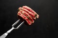 Studio shot of slices of steak on a meat fork Royalty Free Stock Photo