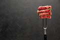 Studio shot of slices of steak on a meat fork Royalty Free Stock Photo