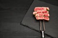 Studio shot of slices of steak on a meat fork Royalty Free Stock Photo