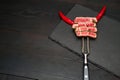 Studio shot of slices of steak on a meat fork Royalty Free Stock Photo