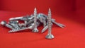 Small hex head screws on a red background Royalty Free Stock Photo
