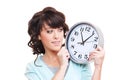 Studio shot of smiley woman looking at clock Royalty Free Stock Photo