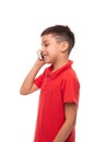 Studio shot of a smiling boy with fashionable stylish haircut talking on the phone on a white Royalty Free Stock Photo