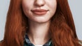 Keep smiling Cropped photo of smiling cute young redhead lady while standing against grey background Royalty Free Stock Photo
