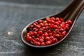 Close up pink peppercorn in spoon dark background Royalty Free Stock Photo