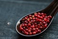 Close up pink peppercorn in spoon dark background Royalty Free Stock Photo