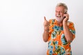 Studio shot of thoughtful happy senior bearded tourist man smili Royalty Free Stock Photo