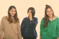 Studio shot of three happy young Asian woman friends smiling and laughing together Royalty Free Stock Photo