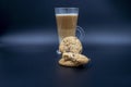 Studio shot of three layered tea drink and chocolate chip cookies in blue ombre background Royalty Free Stock Photo