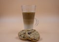 Studio shot of three layered tea drink and chocolate chip cookies with brown ombre background Royalty Free Stock Photo