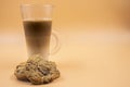 Studio shot of three layered tea drink and chocolate chip cookies in orange ombre background Royalty Free Stock Photo