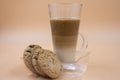 Studio shot of three layered tea drink and chocolate chip cookies in orange ombre background Royalty Free Stock Photo