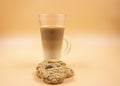 Studio shot of three layered tea drink and chocolate chip cookies in orange ombre background Royalty Free Stock Photo