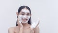 A studio shot of a trans lady smiling with her face covered with soap foam as she is using a gentle facial cleanser Royalty Free Stock Photo