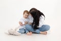 Studio shot of two people, woman and boy having fun and sitting, talking to each other. Happy family. White background Royalty Free Stock Photo