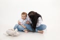 Studio shot of two people, woman and boy having fun and cuddling, talking to each other. Smiling child boy near mother Royalty Free Stock Photo