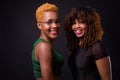 Two young African women together against black background Royalty Free Stock Photo