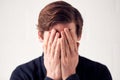 Studio Shot Of Unhappy Man Covering Face With Hands Royalty Free Stock Photo