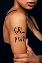 Studio shot of unrecognizable woman with letters `GRL PWR`