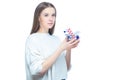 Studio shot of upset disappointed girl holding in her hands a small shopping cart full of expensive pills and medicine Royalty Free Stock Photo