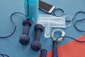 Healthy isnt a goal, its a way of living. Studio shot of a variety of workout equipment and PPE on a red and blue yoga