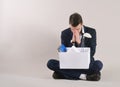 Studio shot of very sad and tired businessman with office stuff