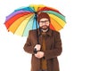 Studio shot on white background of a confident unshaved handsome caucasian man wearing autumnal outfit holding a