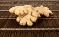 Studio shot of whole ginger on brown mat