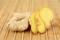 Studio shot of whole ginger on wooden mat