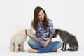 Studio Shot Of Woman With Two Pet Lurcher Dogs