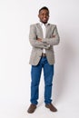 Full body shot of happy young African businessman smiling with arms crossed Royalty Free Stock Photo