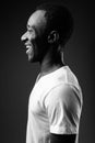 Profile view portrait of young African man smiling in black and white Royalty Free Stock Photo