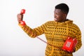 Studio shot of young angry black African man looking at old tele Royalty Free Stock Photo