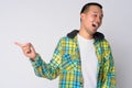 Happy young Asian hipster man laughing while pointing finger Royalty Free Stock Photo