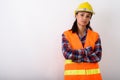 Studio shot of young Asian woman construction worker with arms c Royalty Free Stock Photo